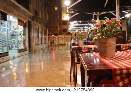 Lisbon Outdoor Restaurant Tables With Red Tablecloths And Flowers