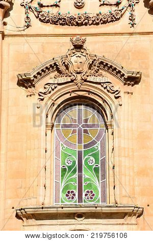 Ornate stained glass window on the front of Naxxar Parish church Naxxar Malta Europe.