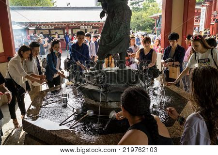 Tokyo - Japan, June 17, 2017; Purify hands and mouth at the temizuya, water pavilion, in front of Senso ji Temple in Asakusa  