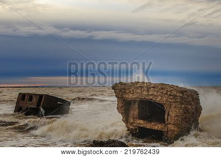Waves beating against Latvia.Liepaja.Karosta. described the fortress ruins