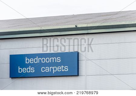 Day View of a Bedrooms Bed Carpets sign.