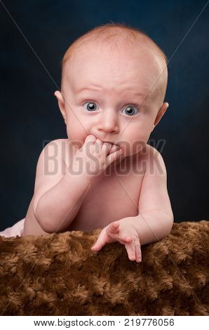 Adorable, Surprised Baby with Blue Eyes and Red Hair