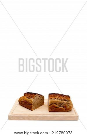 A homemade plumcake standing on a wooden board with a white background