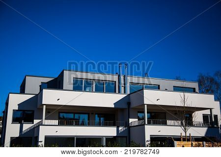 modern multi family house in munich blue sky
