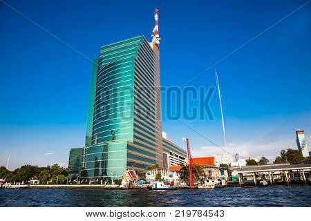 Business district cityscape from Chao Phraya River in Bangkok Thailand.