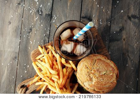 Homemade burger and cheese with fries and icy soft drink