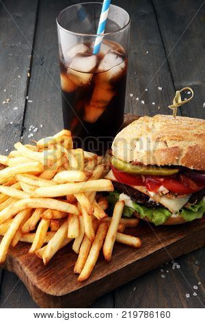 Homemade burger and cheese with fries and icy soft drink