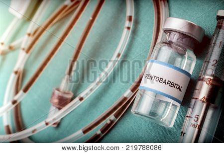 Rubber drip irrigation system with traces of blood along with vial of sodium thiopental, conceptual image