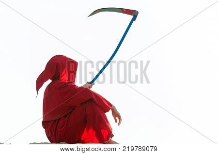 Spooky figure in red cloack with scythe