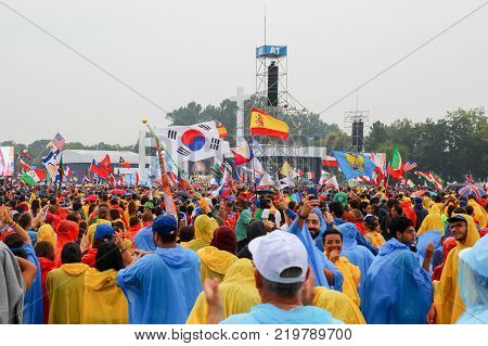 KRAKOW POLAND - 2016: Krakow Blonia World Youth Day 2016 pilgrimi in raincoats listen to the Pope the rain