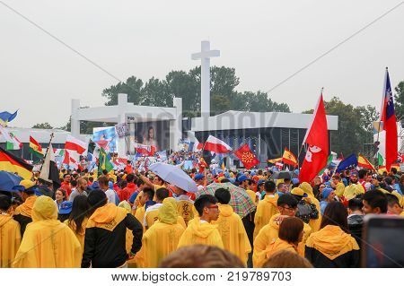 KRAKOW POLAND - 2016: Krakow Blonia World Youth Day 2016 pilgrimi in raincoats listen to the Pope