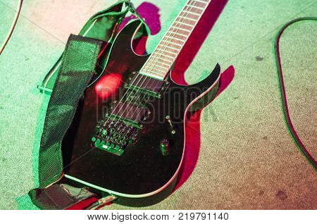 Guitar at the concert. Black bass guitar in Studio lighting.