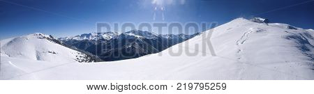 The ascent to the mountain top in a Sunny snowy day. The ascent to Pastukhov mountain.