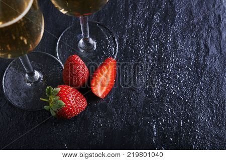 strawberries and champagne glasses on snone background