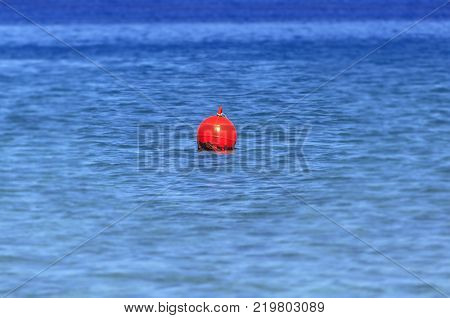 Buoy at blue ocean like mergency sign for sailing boat