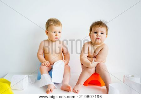 Cute smiling baby sitting on the potty