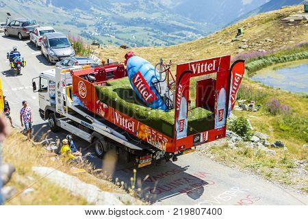 Col de la Croix de Fer France - 25 July 2015: The service truck transports a broken Vittel vehicle on the road to the Col de la Croix de Fer in Alps during the stage 20 of Le Tour de France 2015.