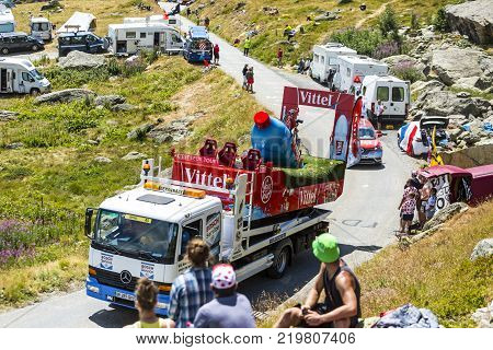 Col de la Croix de Fer France - 25 July 2015: The service truck transports a broken Vittel vehicle on the road to the Col de la Croix de Fer in Alps during the stage 20 of Le Tour de France 2015.