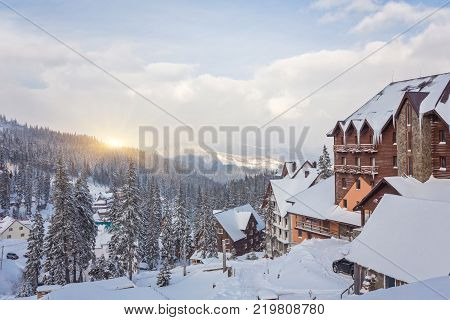 Winter resort with slopes for skiing and snowboarding with houses and lifts