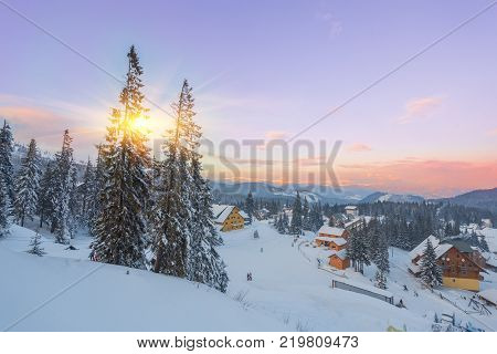 Winter resort with slopes for skiing and snowboarding with houses and lifts
