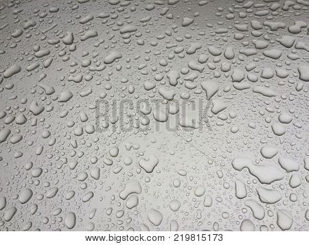 Drops of water on metal. Shallow depth of field.
