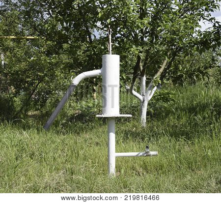 Hand Pump Leading To An Artesian Well. Pumping Water For Watering The Garden.