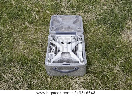 Russia, Poltavskaya village - May 13, 2016: Open case with quadrocopters DJI Phantom 4. The opening of the box on the lawn.