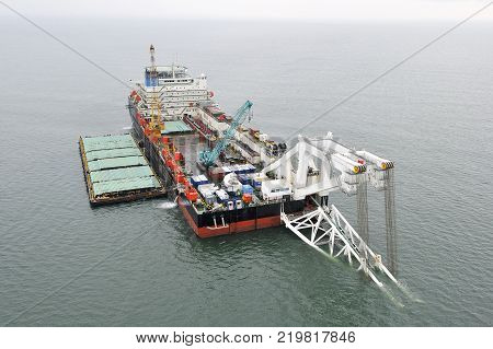 The cargo ship with the crane, the top view. Pipelaying barge.