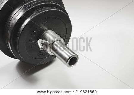Grif rod with rubberized pancakes and lock on white background. Sport shells.