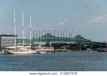 Tobin bridge in Boston, MA, USA and the Athena 295 foot yacht docked at the Boston harbor