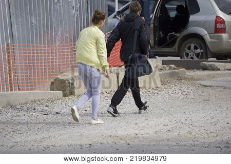 the guy with the girl are near the construction site