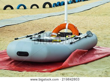 Inflatable Rescue Boat. Gray inflatable boat on the beach in the sand.