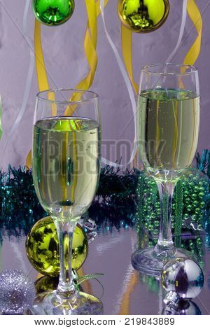 Champagne in glassesgift boxescandle lights and twinkle lights on background.