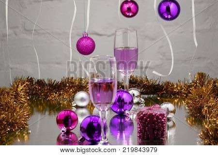 Champagne in glasses and blurred lights on red background