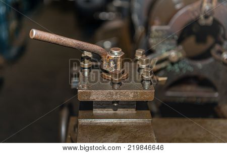 Closeup of a rusty and greasy part of an old machine.