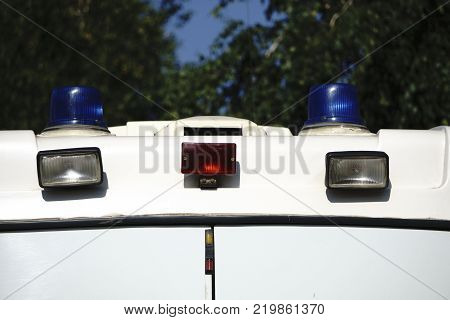 Danger on the road. Blue flasher on the police car at night.