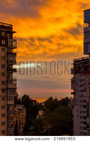 Aerial view of Tonnelnaya street between two apartment buildings and beautiful sky at sunset, Sochi, Russia