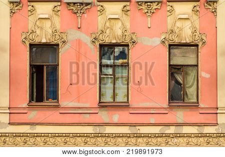 Three windows in a row on the facade of the urban historic building front view, Saint Petersburg, Russia