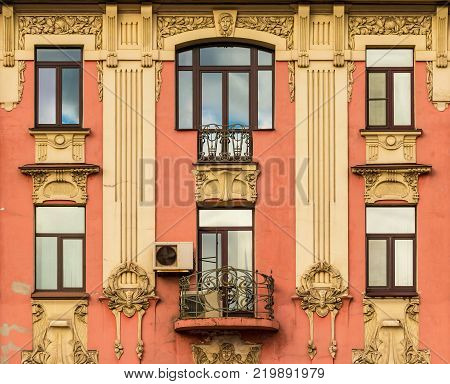 Balcony and several windows in a row on the facade of the urban historic building front view, Saint Petersburg, Russia