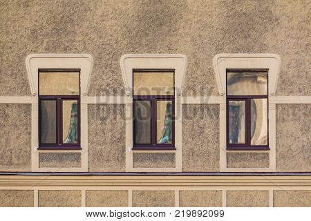Three windows in a row on the facade of the urban historic building front view, Saint Petersburg, Russia