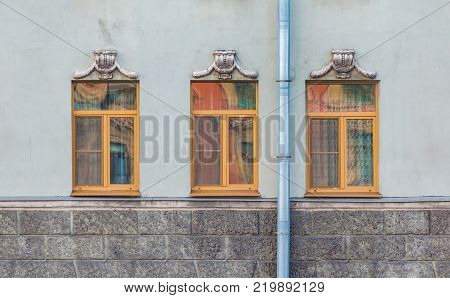 Three windows in a row on the facade of the urban historic building front view, Saint Petersburg, Russia