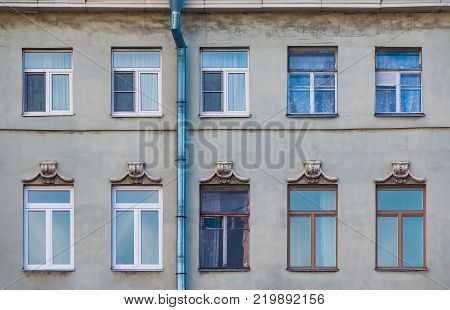 Several windows in a row on the facade of the urban historic building front view, Saint Petersburg, Russia