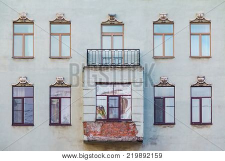 Several windows in a row, bay window and balcony on the facade of the urban historic building front view, Saint Petersburg, Russia