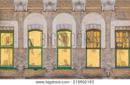 Several windows in a row on the facade of the urban historic building front view, Saint Petersburg, Russia