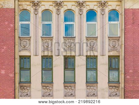 Several windows in a row on the facade of the urban historic building front view, Saint Petersburg, Russia