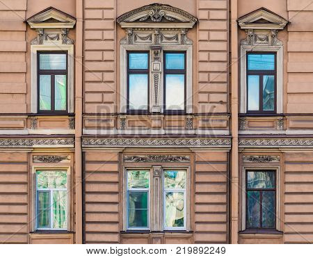 Several windows in a row on the facade of the urban historic building front view, Saint Petersburg, Russia