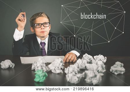 Successfully boy earning money with Blockchain technology. Future for children. Uses laptop. Bitcoin cryptocurrency, bitcoin cash, litecoin, dash, IOTA, ethereum, smart contracts