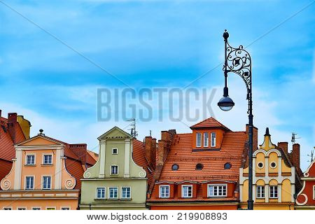 Colorful evening scene on Wroclaw Market Square with vintage streen lanterns. Sunset in historical capital of Silesia Poland, Europe. Artistic style post processed photo.