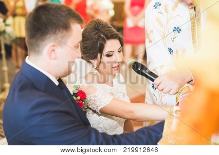 Wedding couple bide and groom get married in a church.