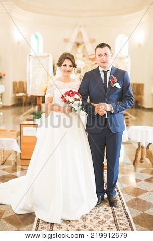 Wedding couple bide and groom get married in a church.
